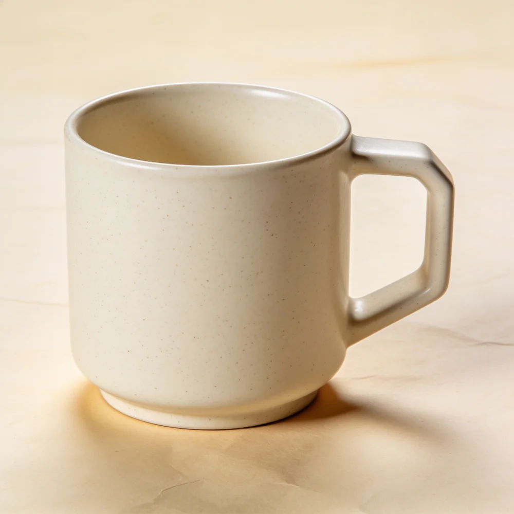 Straight-sided ivory speckled stoneware body, flat base, generous angular D handle